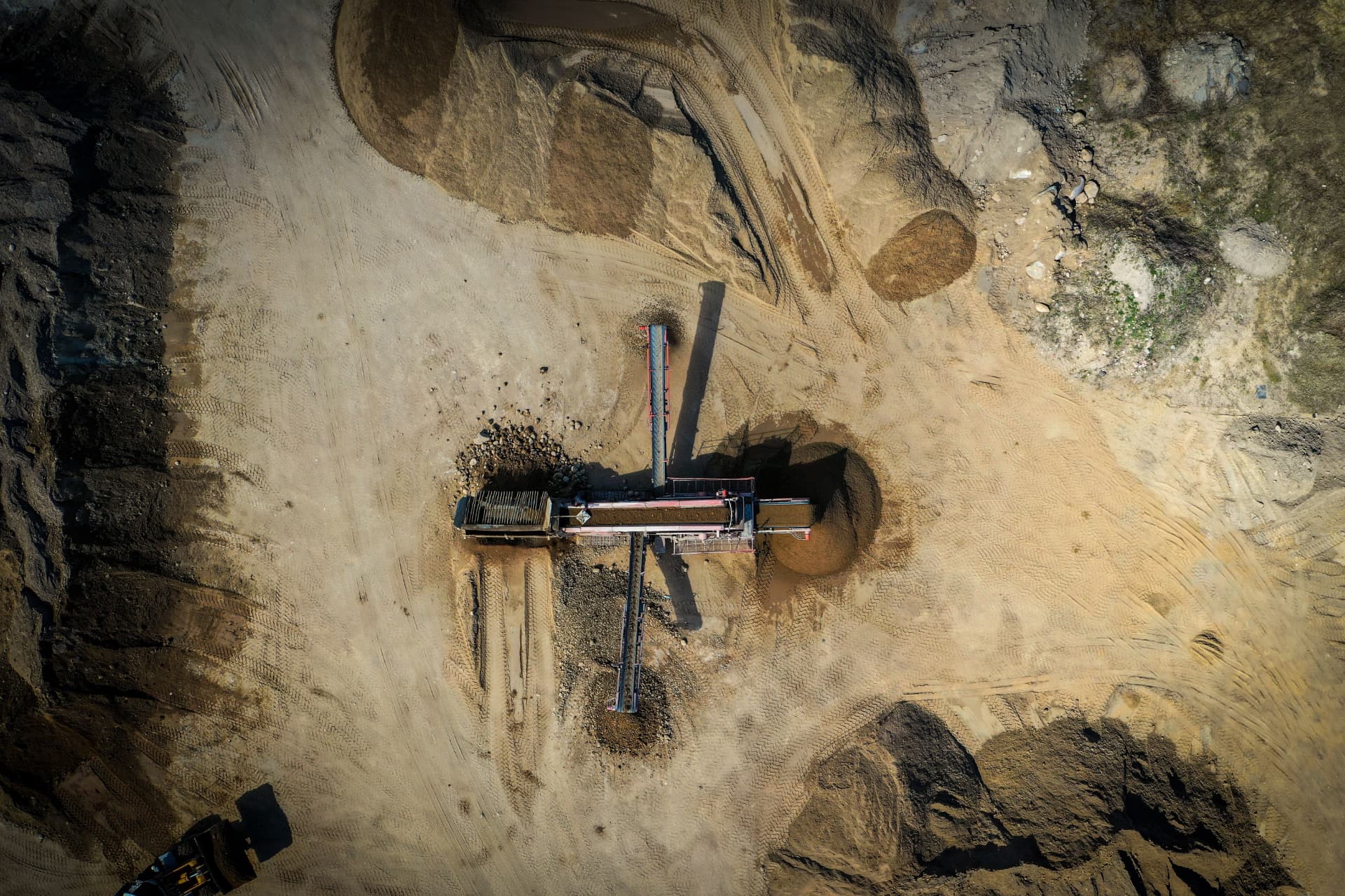 Aerial view of an open-pit mining operation with heavy equipment